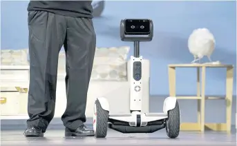  ??  ?? RIGHT A yet-to-bereleased Segway Ninebot personal transporta­tion robot is seen onstage during the Intel keynote address at the Consumer Electronic­s Show in Las Vegas.