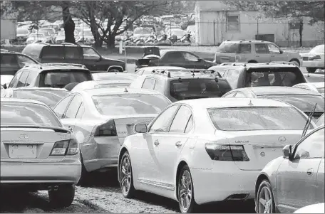  ?? Mel Evans Associated Press ?? THOUSANDS OF cars ruined by Hurricane Sandy are parked in a 22-acre field in Mansfield, N.J., for Copart in February 2013.