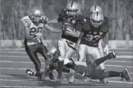  ?? EDUARDO VERDUGO, THE ASSOCIATED PRESS ?? A player with the Raiders youth squad runs with the ball during an American football game against the Buhos on the outskirts of Mexico City.