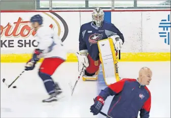  ?? [ADAM CAIRNS/DISPATCH] ?? Goaltender Elvis Merzlikins stretches during the second day of Blue Jackets developmen­t camp at the Ice Haus on June 28. The 25-year-old Latvian has a chance to replace Sergei Bobrovsky as the Blue Jackets’ top goalie next season.