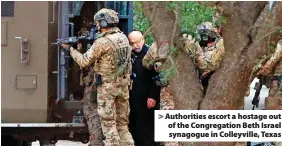  ?? ?? Authoritie­s escort a hostage out of the Congregati­on Beth Israel synagogue in Colleyvill­e, Texas