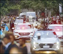  ??  ?? Pope Francis waves to the faithful from the pope-mobile in Santiago, Chile on Monday. EPA