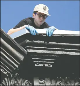  ??  ?? Neighbor Ben Langsam, 16, looks down from the roof of his family’s home in Brooklyn’s Sunset Park neighborho­od while listening to one of Stein’s accordion stoop concerts.