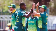  ?? AFP ?? South Africa’s Lungi Ngidi (second from left) celebrates after dismissing Zimbabwe’s Kyle Jarvis during the first one-dayer.