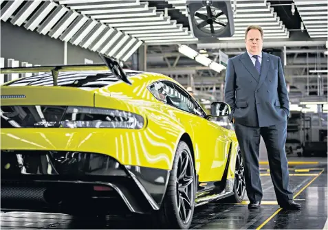  ??  ?? Andy Palmer, chief executive at Aston Martin, with the Vantage GT12 on the production line in Gaydon, Warwickshi­re