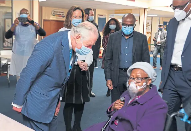  ??  ?? ROYAL VISIT: The Prince of Wales speaks with a member of the public at an NHS vaccine pop-up clinic at Jesus House Church, London.