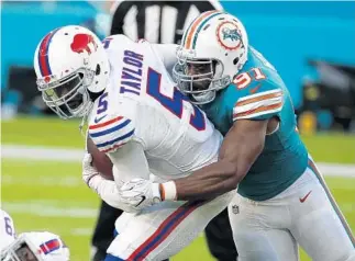  ?? WILFREDO LEE/AP ?? Defensive end Cameron Wake, right, had double digit sacks for the second straight season. He finished with 10.5 sacks in 2017.