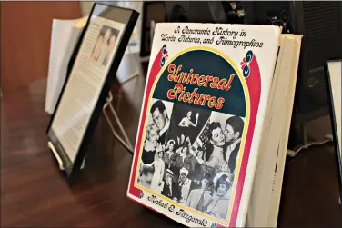  ?? (Caitlan Butler/News-Times) ?? Portions of the South Arkansas Historical Preservati­on Society’s Michael G. Fitzgerald Collection are displayed alongside the Old State House Museum’s “Lights! Camera! Arkansas!” exhibit at the SouthArk Library. Fitzgerald, an El Dorado native, wrote several books on Hollywood history, including “Universal Pictures: A Panoramic History in Words, Pictures, and Filmograph­ies,” pictured here.