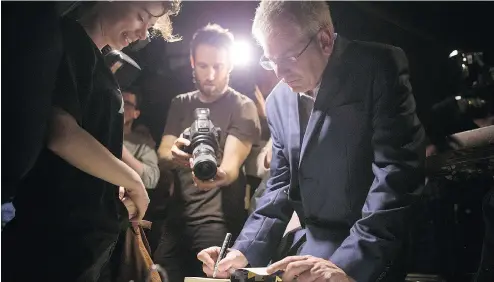  ?? CHRIS YOUNG / THE CANADIAN PRESS ?? NDP MP Charlie Angus signs a book for a supporter after announcing his intention to run for the NDP federal leadership at a rally in Toronto on Sunday. He becomes the second candidate to officially enter the race.