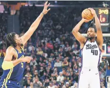  ?? — AFP photo ?? Barnes (right) of the Sacramento Kings shoots over Kevon Looney of the Golden State Warriors in the first half at Chase Centreo in San Francisco, California.