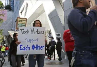  ?? SAMANTHA MALDONADO- THE ASSOCIATED PRESS ?? In this photo taken July 16, tech workers march to support Facebook’s cafeteria workers, who were rallying for a new contract with their company Flaghship in San Francisco. Tech workers are speaking out on issues of immigratio­n, the environmen­t, sexual misconduct and military warfare like never before. Google, Amazon and Microsoft employees protest against how their work is used by the government. Through petitions and collective actions, others push for better internal policies, greener practices and better work conditions for contractor­s.