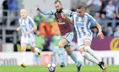  ?? John Rushworth ?? Huddersfie­ld’s Abdelhamid Sabiri battles with Burnley’s Steven Defour during Saturday’s clash