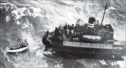  ??  ?? Survivors in a lifeboat shelter in the lee of a rescue ship after the sinking five miles off the Irish coast