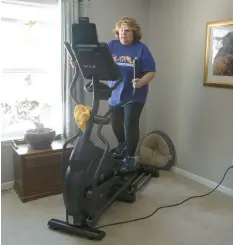  ?? POST-TRIBUNE ?? Respirator­y therapist Theresa Camarena works out on an elliptical trainer in her Hobart home on Friday.