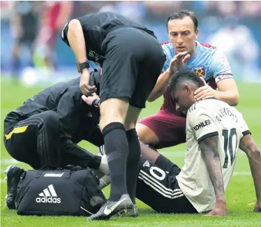  ??  ?? More agony: Marcus Rashford shows his pain after picking up an injury in defeat to West Ham