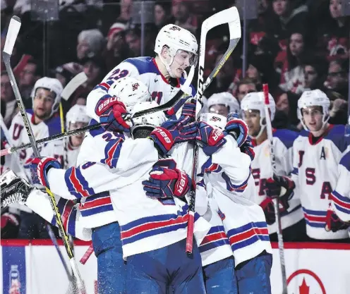  ?? MINAS PANAGIOTAK­IS/ GETTY IMAGES ?? Kieffer Bellows of Team United States celebrates a second period goal with teammates Thursday night.