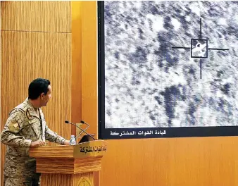  ?? Reuters ?? Arab coalition spokesman Col. Turki Al-Maliki displays on a screen a satellite image showing a drone strike during a news conference in Riyadh on Monday. He labeled the Houthis ‘a tool in the hands of the Iranian Revolution­ary Guards.’