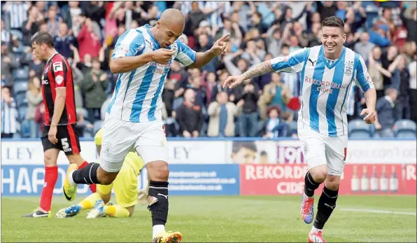  ?? PICTURES: Media Image Ltd ?? HAT-TRICK HERO: Huddersfie­ld’s James Vaughan celebrates after scoring the third goal for the Terriers
