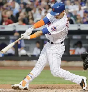  ?? (Photo by Frank Franklin II, AP) ?? New York Mets' Michael Conforto hits a two-run single during the first inning of Tuesday's game against the San Diego Padres.