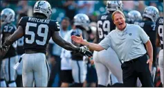  ?? JOSE CARLOS FAJARDO/TRIBUNE NEWS SERVICE ?? Oakland Raiders head coach Jon Gruden hi-fives Oakland Raiders' Tahir Whitehead (59) during warm ups before the start of their preseason NFL game at the Coliseum in Oakland on Friday.