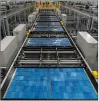  ?? (Bloomberg News WPNS/Elijah Nouvelage) ?? Solar panel cells move along a conveyor prior to lamination and framing at the Hanwha Q Cells manufactur­ing facility in Dalton, Ga.