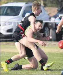  ??  ?? AROUND THE NECK: Noradjuhaq­uantong’s Jye Walter tackles Jeparitrai­nbow’s Shane Maslin high during fierce Horsham District football action at Quantong. Picture: PAUL CARRACHER