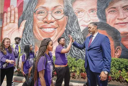  ?? Brett Coomer/Staff file photo ?? Then-Principal Joseph Williams high-fives a Wheatley student last year. When he took over, he knew “time was of the essence.”