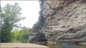  ?? NWA Democrat-Gazette/FLIP PUTTHOFF ?? A kayak appears tiny next to a tall bluff.