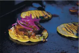  ??  ?? Tacos prepared by chef Mike Winneker appear at a makeshift kitchen outside of his home on April 3, in Scottsdale, Ariz.