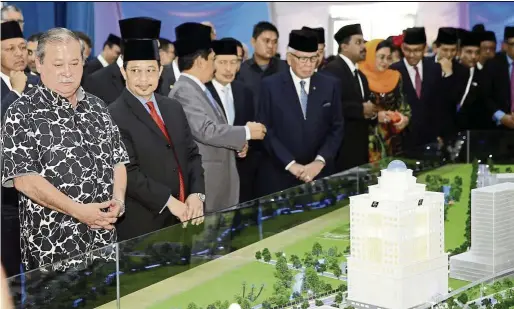  ??  ?? sultan Ibrahim Ibni Almarhum sultan Iskandar ( left) looking at the model of the new Ibrahim Internatio­nal Business District ( IIBD) during the project launch in november last year.