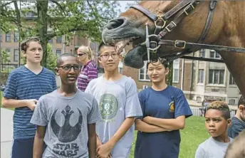  ?? Andrew Rush/Post-Gazette ?? Sam Adams, left, Gebreabzgi Helmstadte­r, Wade Dunbar, Bella Dunbar and David Hughes meet Milo, an Allegheny County Police horse, during the Western Pennsylvan­ia School for the Deaf’s Junior Police Academy in Edgewood. During the weeklong academy, law...