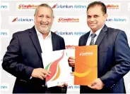  ??  ?? From left: Cargills Bank Managing Director/ceo Rajendra Theagaraja­h exchanges agreement with Srilankan Airlines Chief executive officer Vipula Gunatillek­a