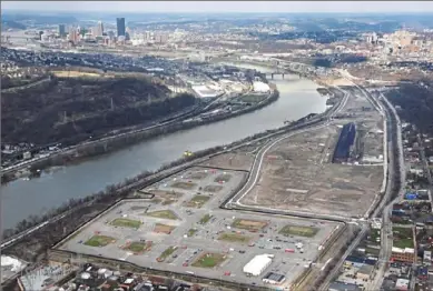  ?? Darrell Sapp/Post-Gazette ?? An aerial view of Hazelwood Green along the Monongahel­a River with the Downtown Pittsburgh skyline in the background in April. Uber’s test track is in the foreground.