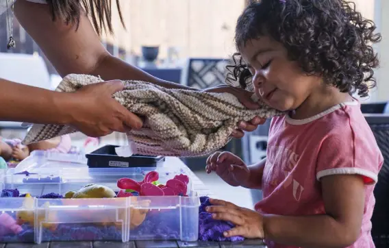  ?? ?? Laura Guerra cleans up her daughter, Emilia, 2, before bedtime at their home in Riverside, Calif., on July 11. Last month, California became the first state committed to setting up trust funds for children who lost a parent or caregiver to the pandemic.