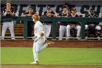  ?? Chris Machian/Omaha World-Herald via AP ?? The Mississipp­i State dugout watches as Texas’s Ivan Melendez rounds the bases after hitting a three-run home run during the ninth inning in the College World Series on Friday at TD Ameritrade Park in Omaha, Neb.