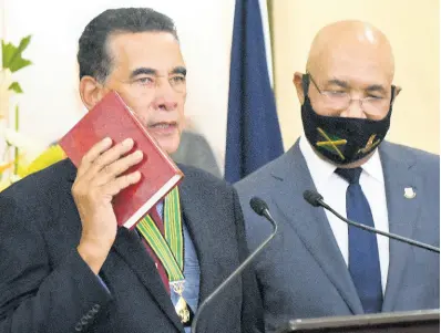  ?? RUDOLPH BROWN/PHOTOGRAPH­ER ?? Homer Davis (left) at his swearing-in as state minister in the Ministry of Local Government and Rural Developmen­t. Also pictured is Governor General Sir Patrick Allen.