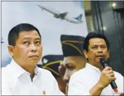  ?? ROMEO GACAD/GETTY IMAGES ?? Indonesian Transport Minister Ignasius Jonan, left, listens Sunday as Director General for Air Transporta­tion Suprasetyo announces that a missing plane carrying 54 people had crashed into a Papua mountain.