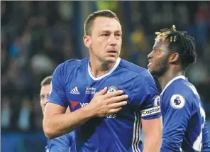  ?? HANNAH MCKAY / REUTERS ?? Chelsea captain John Terry, who will leave the Blues this summer, taps his heart after scoring the Premier League champion’s first goal in its 4-3 win over Watford on Monday.