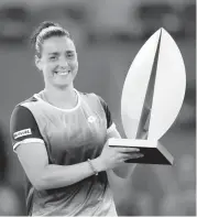  ?? MANU FERNANDEZ AP ?? Ons Jabeur holds the winner’s trophy at the end of the women’s final at the Mutua Madrid Open after defeating Jessica Pegula of the United States.