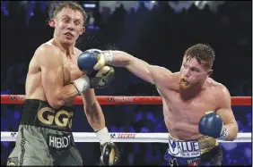  ?? AP PHOTO ?? Canelo Alvarez, right, connects with a right to Gennady Golovkin during a middleweig­ht title fight Saturday in Las Vegas.