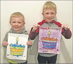  ??  ?? Nicklaus Hittepole, 4 and Ethan Hittepole, 6 from New Knoxville with their entries for the coloring contest for The United Way of Auglaize County