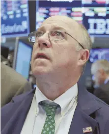  ?? AP PHOTOS ?? ON THE REBOUND: Trader Frederick Reimer, above, eyes the monitors on the trading floor of the New York Stock Exchange yesterday. Also at attention are Kevin Lodewick and Paul Cosentino, at left.