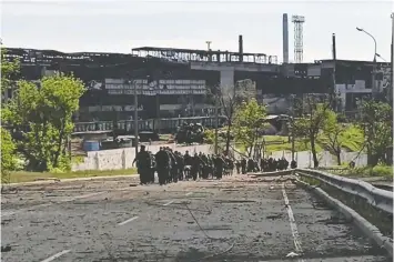  ?? — GETTY IMAGES ?? An image released by the Russian Defence Ministry Wednesday shows Ukrainian service members leaving the besieged Azovstal steel plant in Mariupol.