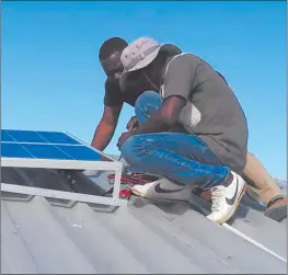  ??  ?? Godsend… Technician­s seen installing the donated solar system at the school