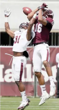  ?? (Photo by Rogelio V. Solis, AP) ?? Mississipp­i State defensive back Tolando Cleveland, left, breaks up a pass during the 2014 Maroon-White Spring Football Game.