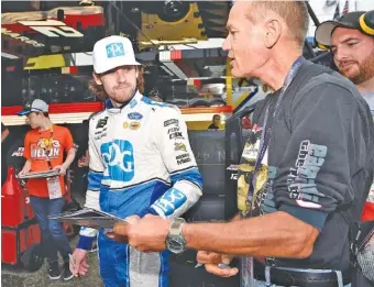  ?? AP PHOTO/NICK WASS ?? NASCAR driver Ryan Blaney signs autographs before a Cup Series practice session Friday at Dover Internatio­nal Speedway in Delaware. Blaney won last weekend on the roval course at Charlotte Motor Speedway.