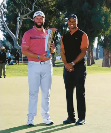  ?? RYAN KANG/AP ?? Jon Rahm and Tiger Woods pose for photos Sunday after Rahm’s victory at the Genesis Invitation­al in Los Angeles. The 47-yearold Woods was the tournament host and made his season debut in the event, finishing in a tie for 45th.