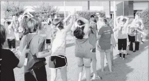  ??  ?? Fifth- grade students had to pass a wet sponge over their heads and under their legs to fill a bucket to win water games during vacation Bible school at New Hope Christian Church.