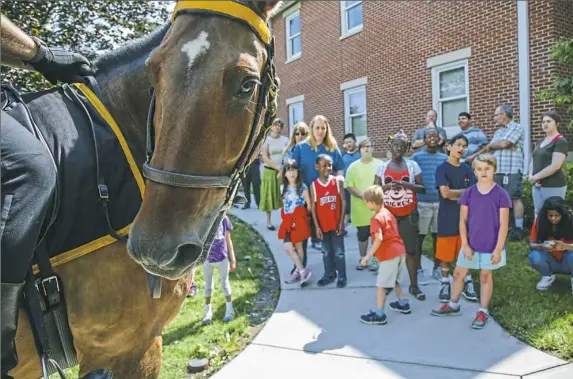  ?? Andrew Rush/Post-Gazette photos ?? Milo, ridden by Officer Christophe­r Swanson of the Allegheny County Police Mounted Unit, visited the Western Pennsylvan­ia School for the Deaf in Edgewood during this week’s Junior Police Academy activities.