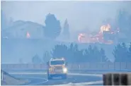  ?? JASON BEAN/ THE RENO GAZETTE- JOURNAL VIA AP ?? Firefighte­rs battle the Pinehaven Fire in the Caughlin Ranch area of Reno, Nev., on Nov. 17.